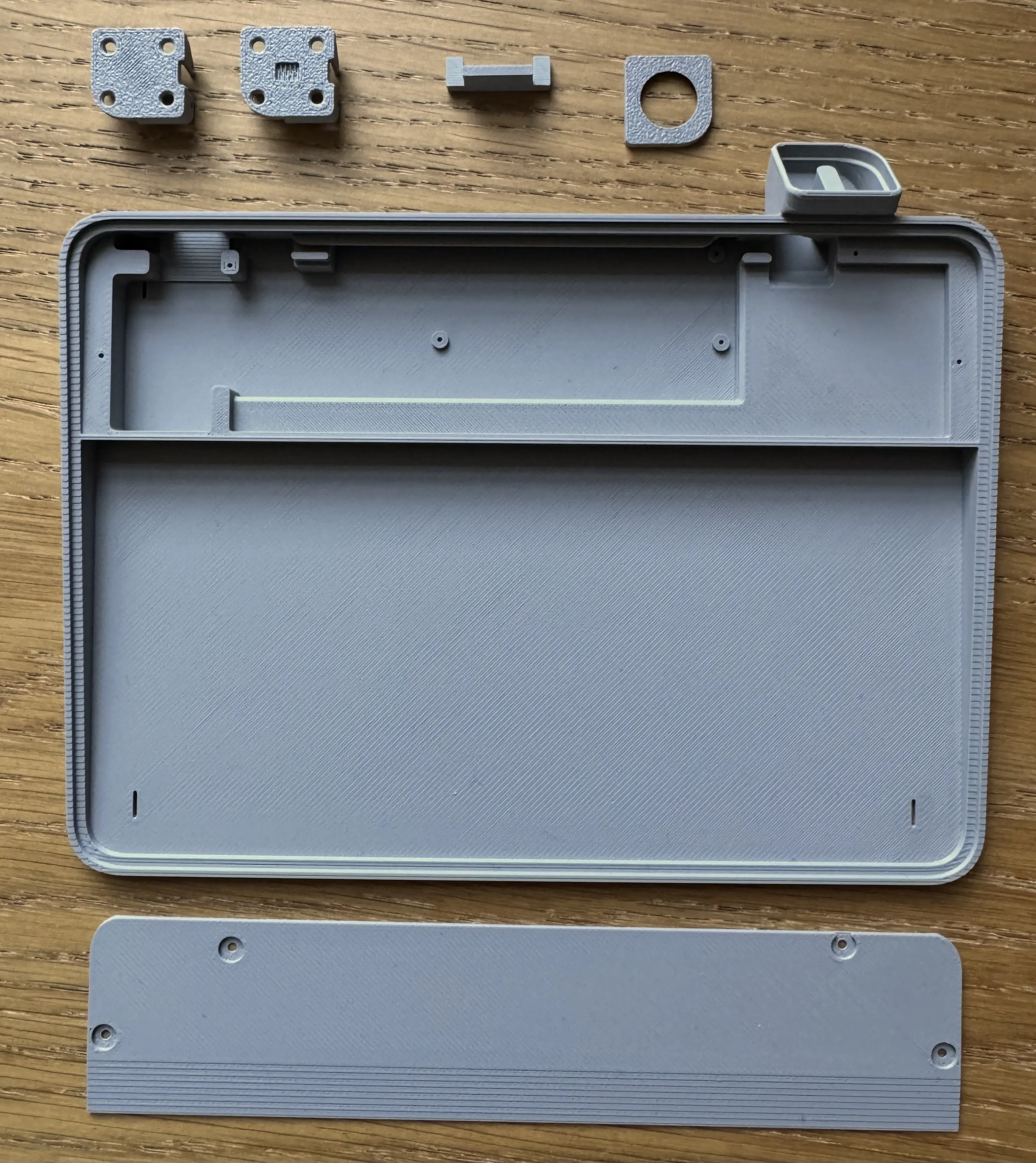 3D printed parts. Two click plates, keycap cover, USB-C wedge, main case, and lid are shown.